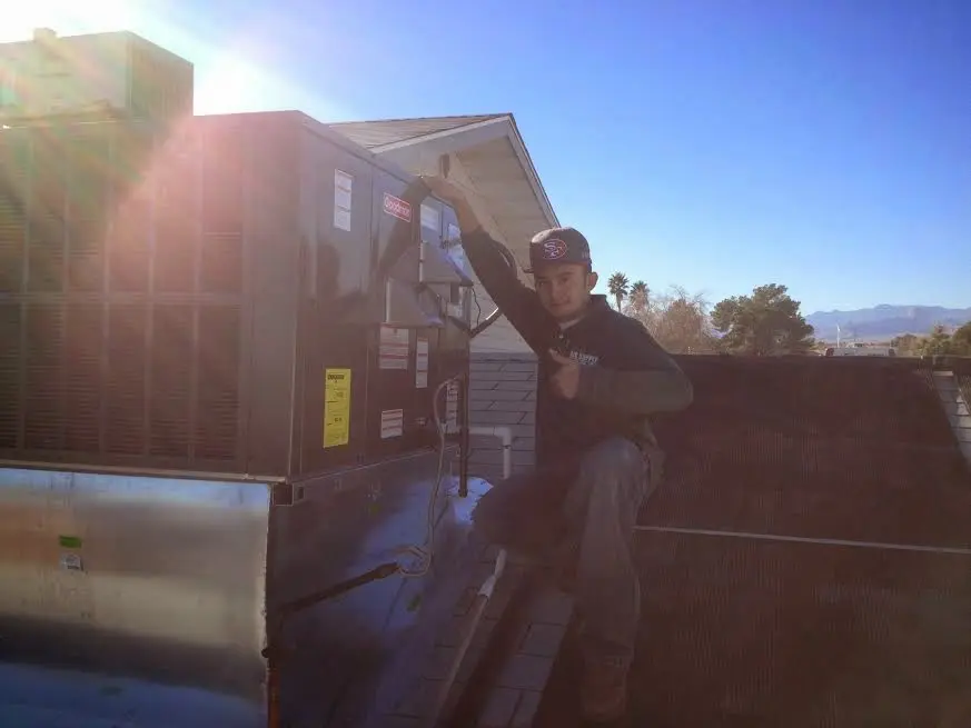 HVAC technician performing HVAC Inspection on a rooftop unit in Montclair